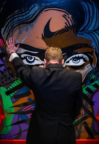 funny photo of the best man in the rest room at a quirky wedding venue