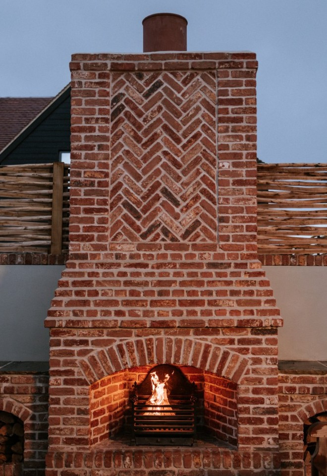 Brickfire place and roaring fire in The Harty Estate courtyard