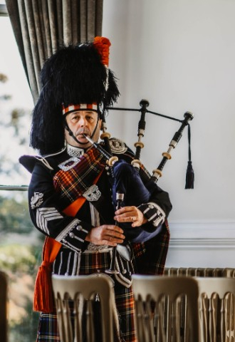 Piper at Auchen Castle - a romantic castle wedding venue in Scotland