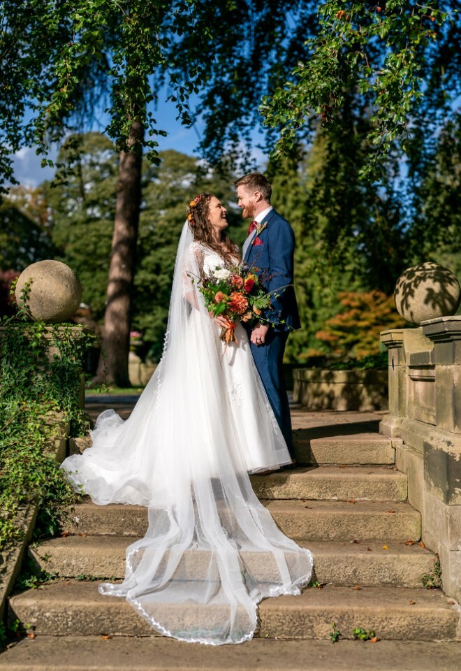 bride and groom on steps on wedding day.