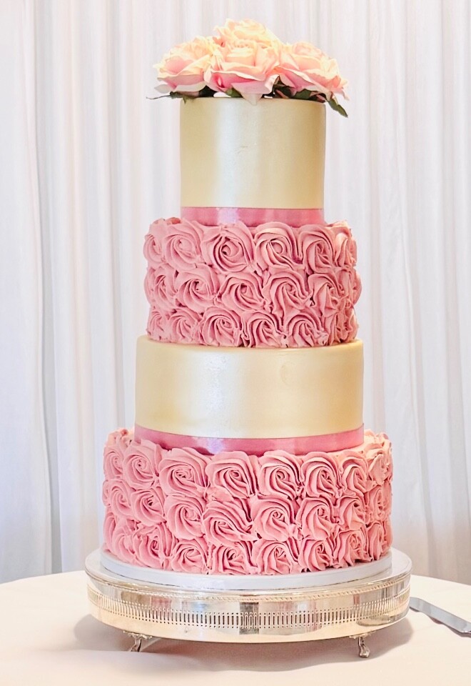 Beautiful hand piped buttercream swirls with alternate fondant tiers decorated with artificial flowers 