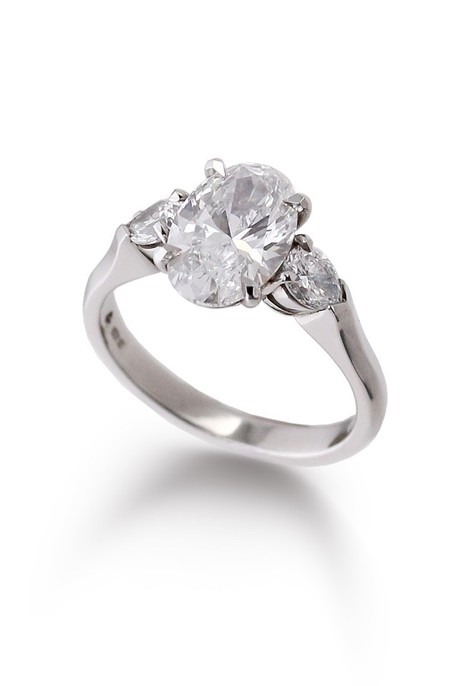Oval Lab grown diamond with two pear shape diamonds either side in a beautiful platinum engagement ring