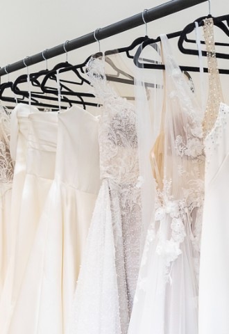 Selection of wedding dresses hanging up for brides to try on in Your Story bridal boutique