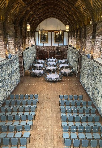 Wedding ceremony set up and wedding breakfast indoors at Hatfield House