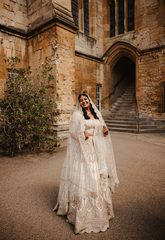 Bride standing in front of the stairs at New College Oxford