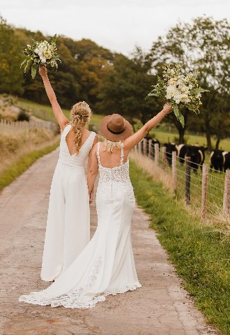 Brides holding up bouquets in Posy and Pearl Bridal Boutique gowns 