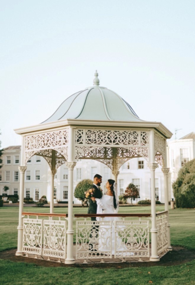 Couple getting married outside at Burnham Beeches Hotel, the Wedding Pavilion
