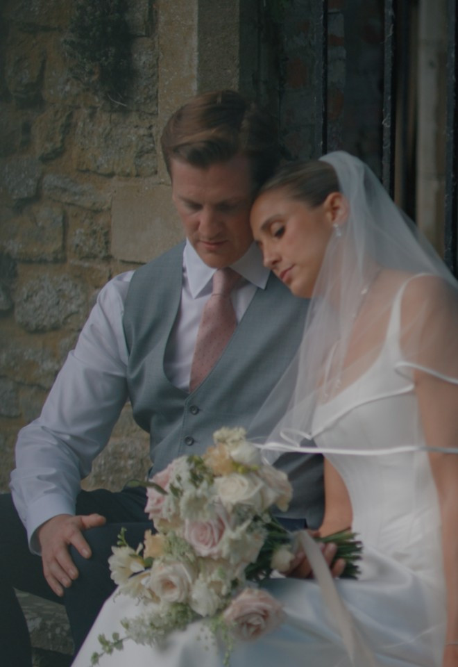 Bride and groom in the gardens at Tythe Barn, Oxfordshire, captured by Dean Sherwood Wedding Films, Hertfordshire wedding videographer.