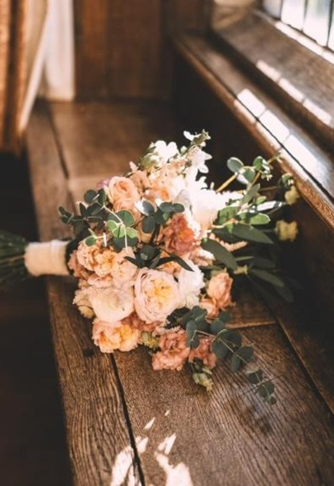 Peach coloured flowers in rustic bridal bouquet