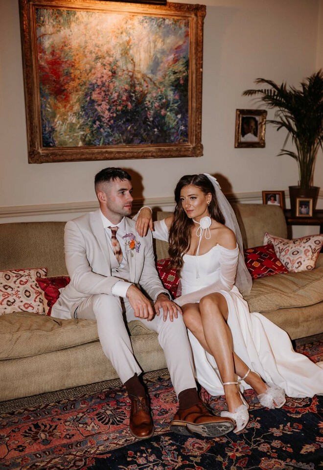 wed couple sitting on sofa