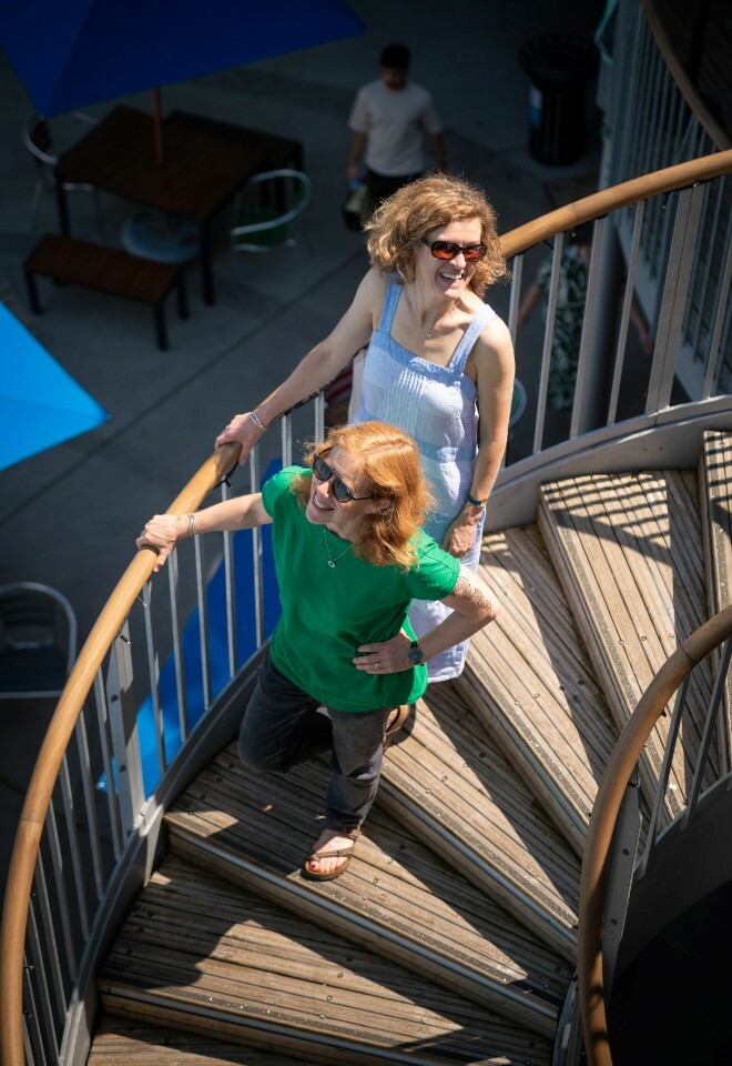 Two People Stood on Spiral Staircase in the Sunshine