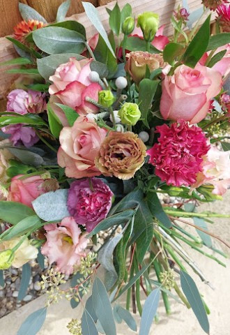 Natural bouquet of roses and textures in antique pinks with eucalyptus foliage