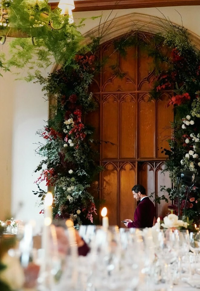 Groom stood in front of doorway with Wedding Flowers from Hanako Flowers