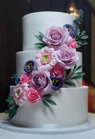 Pink and Purple Sugar Roses, Gerbera and Lisianthus on Classic White Wedding Cake