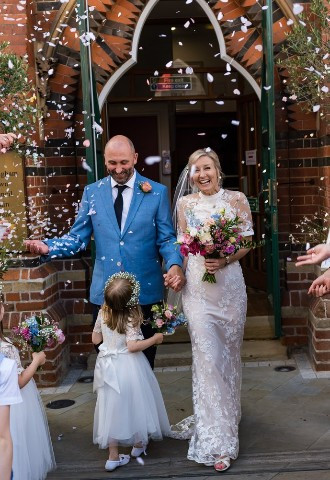 Bride and groom being showered in confetti at Wokingham Town Hall, Berkshire