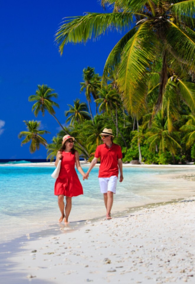 Wedding couple on Honeymoon walking along the beach in the Maldives, Not Just Travel James & Natasha