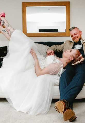 Bride and Groom sat on the sofa in our honeymoon cottage
