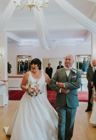 Bride walking down the aisle at Glen Yr Afon House Hotel