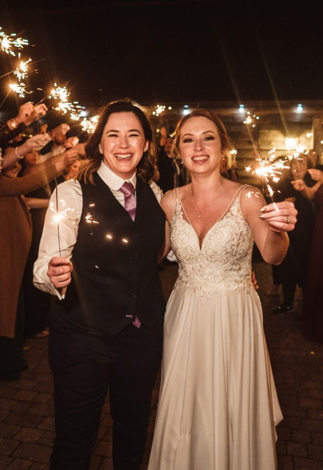 LGBT couple celebrate their wedding day with sparklers