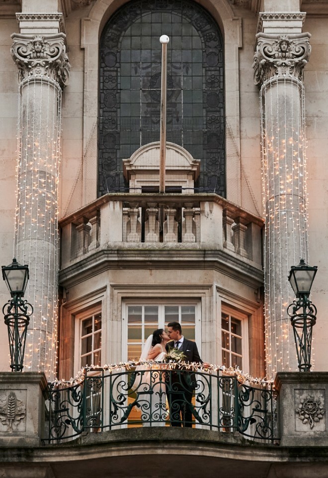 colchester town hall wedding, bride & groom on balcony with fairy lights, essex wedding venue
