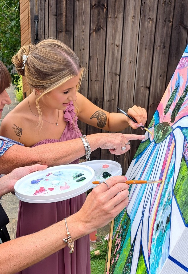 guest painting at wedding