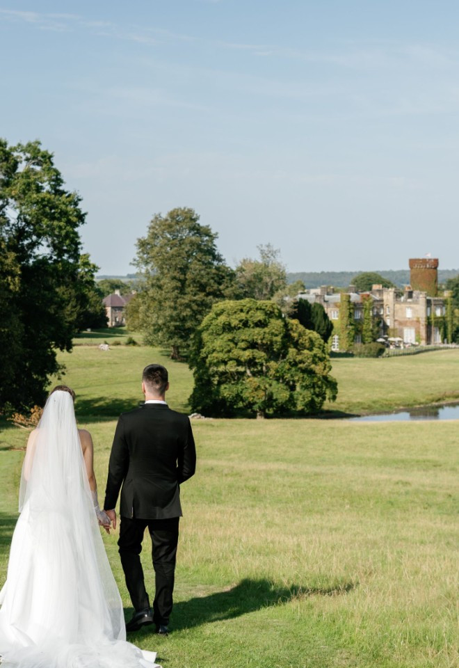 Wedding Couple looking back at Swinton Park Hotel