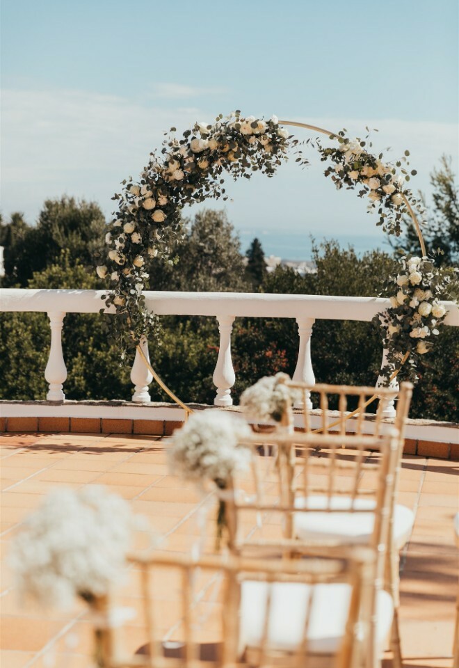 Circular Wedding Arch at Casa Monte Cristo Tres for a Ceremony with Aisle Chair Flowers