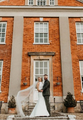 Bride and groom outside manor