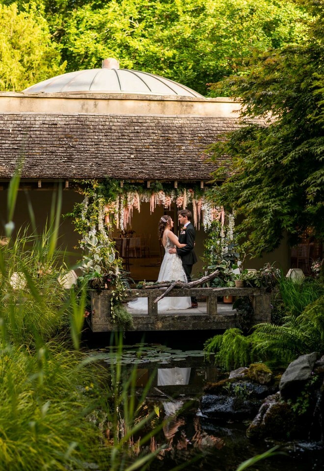 Bride and groom standing near the pond