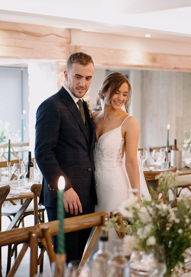 Bride and groom admire wedding breakfast setting inside Wild Thyme & Honey