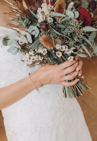 Wedding band on brides finger holding bouquet during styled shoot in Oxfordshire