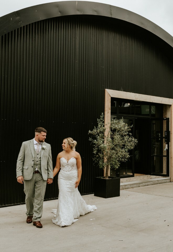 Couple holding hands outside The Shack 