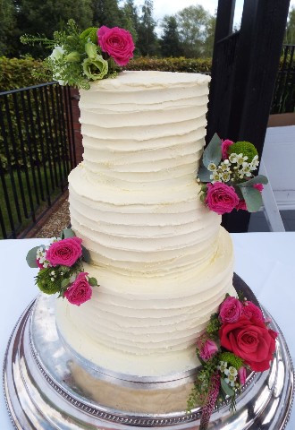 Three tier white wedding cake with fresh flower decoration, Gails Cake Pantry, Powys