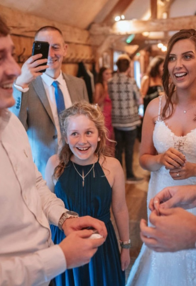 magician does a mind reading trick with wedding guests