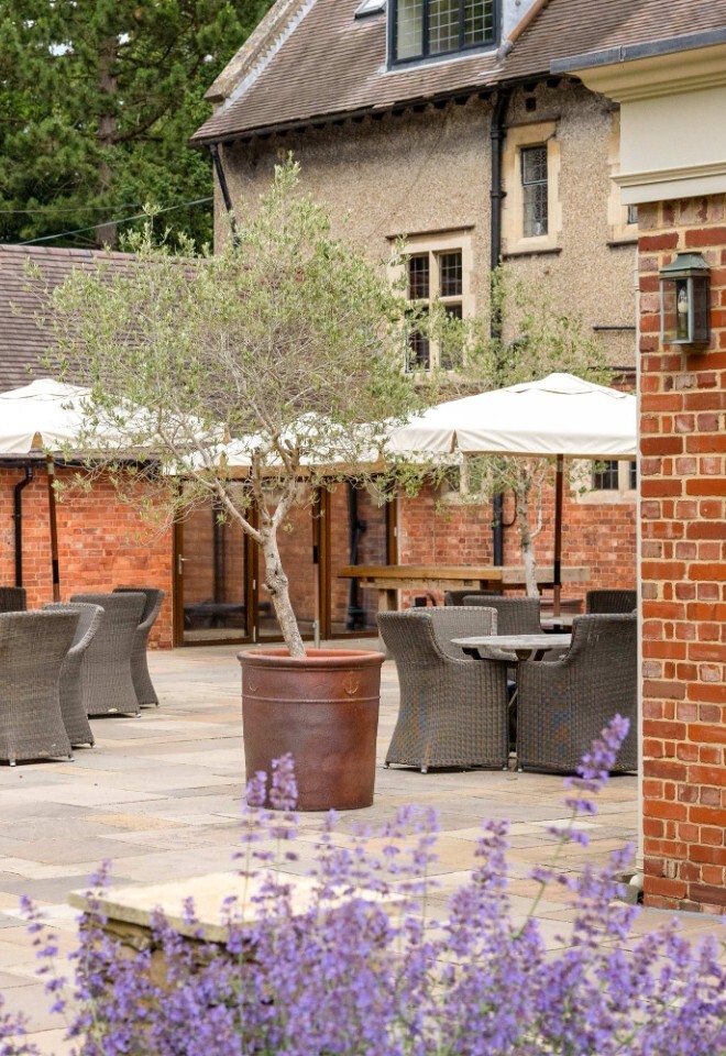 The grounds and patio area with flowers at a Northamptonshire country wedding venue