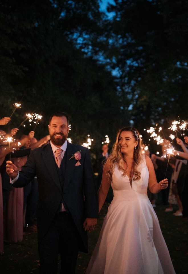 The bride and groom celebrating with sparklers at a Northamptonshire country wedding venue