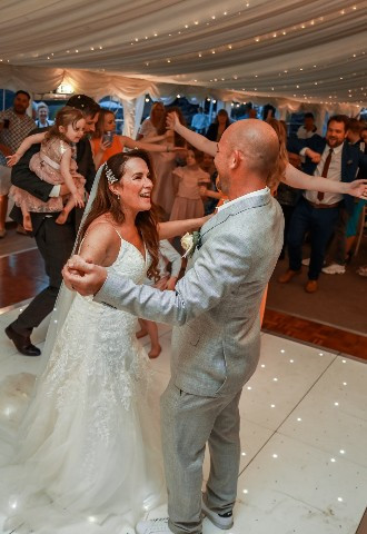 Bride & Groom first dance at The Stables Wedding Farm Oldham marquee wedding venue with starlit floor and wedding DJ