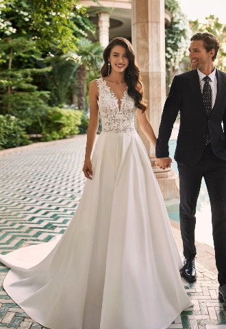 Azuri from Adriana Atlier 2024 collection. Lace V neckline satin skirt, found at Boa Boutique Surrey
