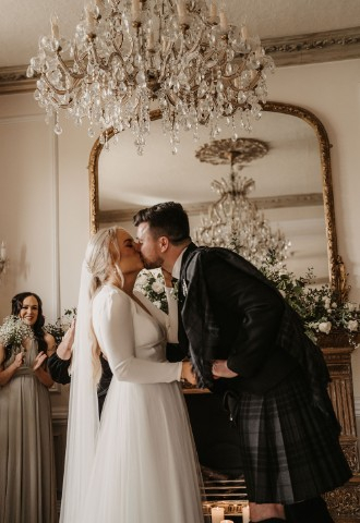 Bride & groom kissing at Auchen Castle - romantic castle wedding venue in Scotland