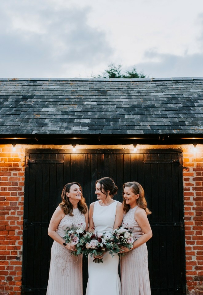 Bridal party photo in the Stable Courtyard at Copdock Hall wedding venue Suffolk