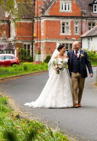 Bride and groom walking around the grounds at Coed Y Mwstwr Hotel, Bridgend