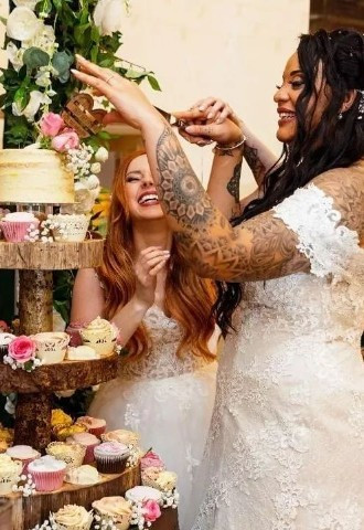 Two bride cutting their wedding cake by Gails Cake Pantry, Powys