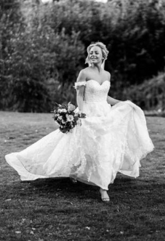 Black & white photo of the bride running in her dress- Sprowston Manor Norwich