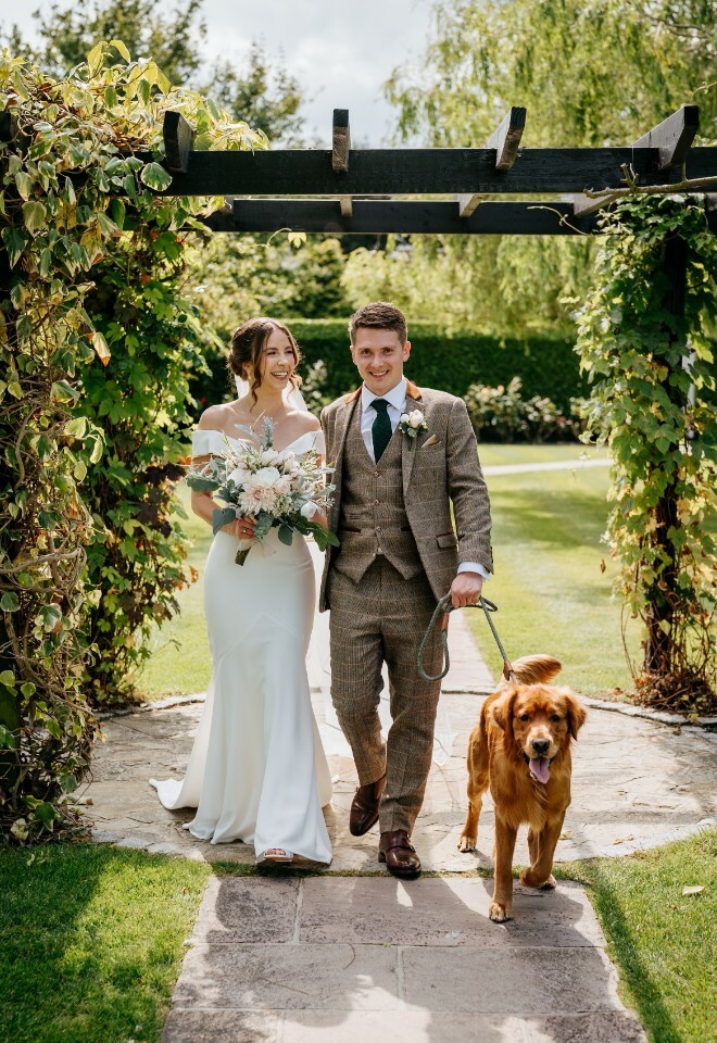 Bride and groom with dog at wedding