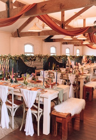 large renovated barn room with wedding dining set up