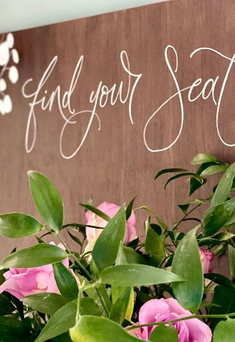Wooden table seating plan sign in white ink by Mint Lettering calligraphy Buckinghamshire