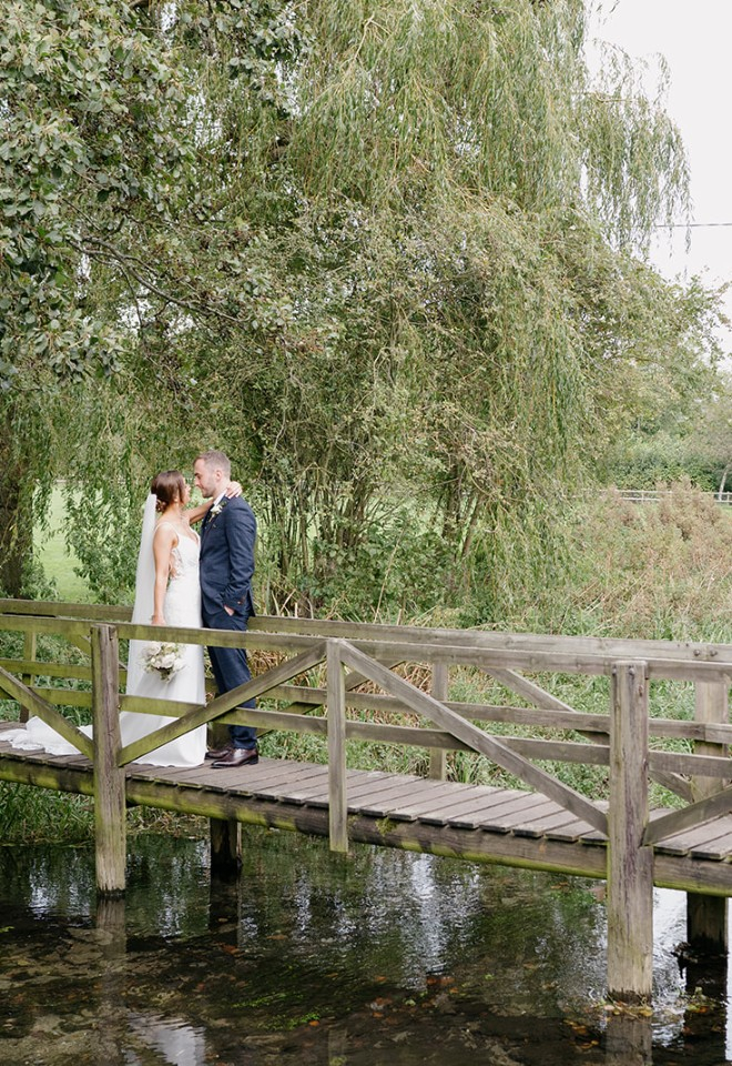 Bride and groom on bridge at Wild Thyme & Honey