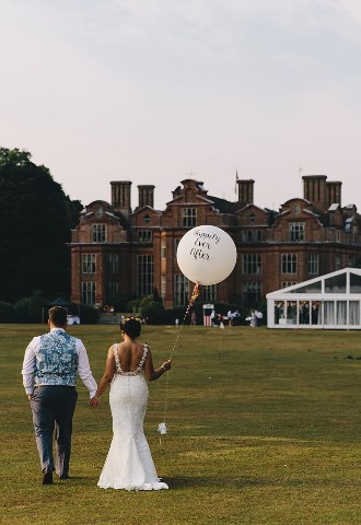 Bride and groom exploring the grounds at Broome Park, Kent