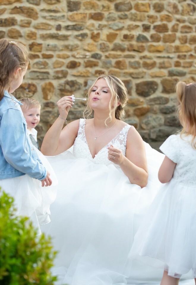 bride with flower girls blowing bubbles