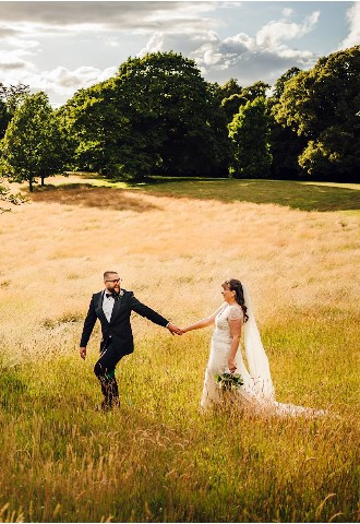 Bride and groom exploring the grounds at Hagley Hall, Worcestershire